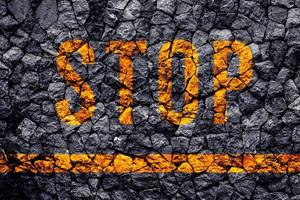 Stop text written with broken cement wall, Stop word on street. photo