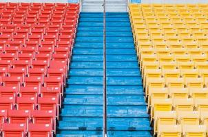 Empty orange and yellow seats at stadium,Rows of seat on a soccer stadium photo