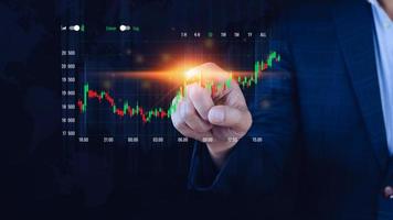 Businessman finger touch symbol stock graph and chart background, concept growth and development business investment, Stock market and strategy making market plan and stock market fluctuations photo