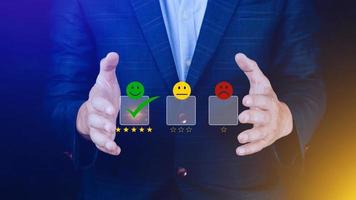 Businessman choosing happy smile face icon. feedback rating and positive customer review experience, satisfaction survey. mental health assessment. photo