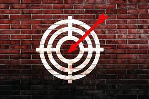 Target figure on brick wall, concept of achieving goal quality, Aim Target Red Symbols of goals and objectives over brick wall background. Business idea photo