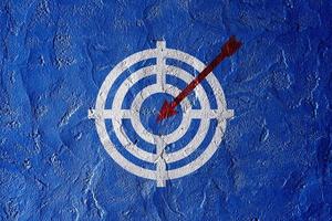 Target figure on blue wall, concept of achieving goal quality, Aim Target Red Symbols of goals and objectives over blue wall background. Business idea photo