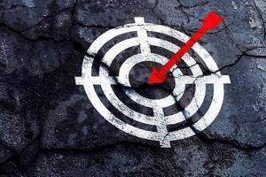 Target figure on broken wall, concept of achieving goal quality, Aim Target Red Symbols of goals and objectives over grunge background. business idea photo
