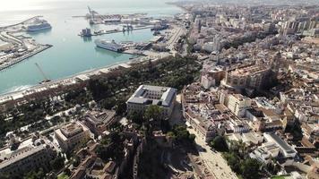 Malaga city center with port in background, Spain. Aerial drone view video