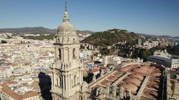 Pullback from Malaga Cathedral tower, Revealing Spanish cityscape. Spain video