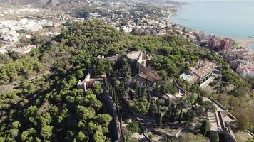 Gibralfaro castle overlooking Malaga city. Aerial reverse video
