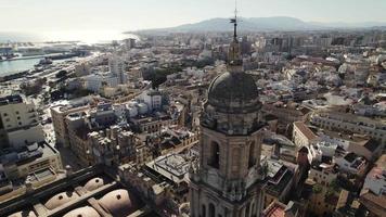 Aerial parallax of grand Malaga Cathedral tower, historic Catholic church