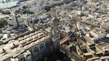 Topdown view Malaga Cathedral tower bell surrounded by downtown buildings, Spain video