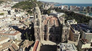 Malaga Cathedral facade with panorama city views, Aerial Orbiting. Andalusia. Spain