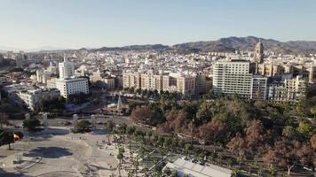 Aerial approaching Malaga historic center. Malaga skyline against blue sky and hills. video