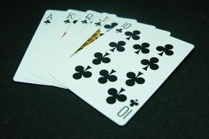 Royal Flush of Clubs , All the same suit, sequence A-K-Q-J-T in black background photo