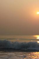 The sun is rising, the sun is bright, the morning sea at Cha-Am Beach photo