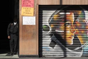 MEXICO CITY, MEXICO - JANUARY 30 2019 - All the shops roll down gates have spray painted graffiti photo