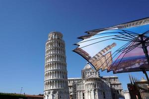 PISA, ITALY - SEPTEMBER 26 2017 -  migrants selling merchandise at famous leaning tower photo