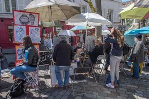 PARIS, FRANCE - MAY 1 2016 - Artist and tourist in Montmartre photo