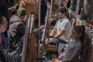 PARIS, FRANCE - MAY 1 2016 - Artist and tourist in Montmartre photo