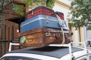 Old luggages atop of a retro car photo