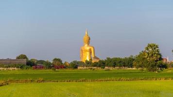 The back of a large golden yellow buddha At Wat Muang, which is an important religious tourist destination In Ang Thong Province in Thailand photo