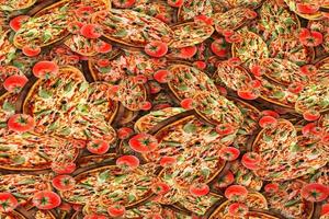 A large number of tomatoes with pizza seamless pattern background photo