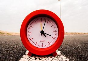 Red clock on the road photo