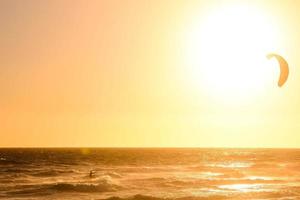 Kitesurfer at sunset photo