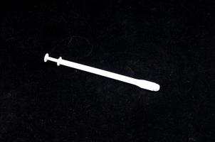 Syringe on dark background photo