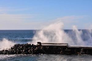 Huge sea waves crashing on the shore photo