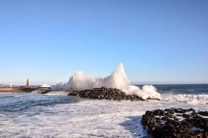 Huge sea waves crashing on the shore photo