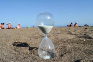 Hourglass in the sand photo