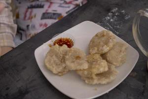 Close up photo of Cireng traditional food of Sundanese West Java. Fried flour with traditional chili sauce. The photo is suitable to use for Indonesia traditional food background, food poster.