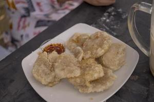 Close up photo of Cireng traditional food of Sundanese West Java. Fried flour with traditional chili sauce. The photo is suitable to use for Indonesia traditional food background, food poster.