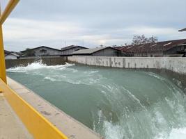 Texture and surface of seawater fall on the power plant with foaming on the outfall. The photo is suitable to use for industry background, environment poster and nature content.