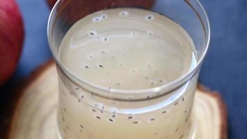 Seed apple juice in a glass on table video