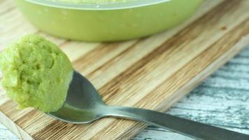 Avocado spread on a a spoon on chopping board video