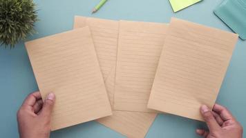 Top view of man's hand on blank paper on table video