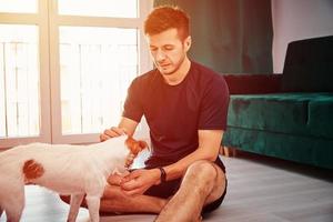 Man doing sport exercise with his dog photo