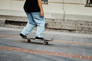 Skateboarder ride on skateboard at city street, close up photo