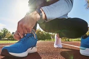 Runner get ready for run, tying sneakers shoelaces photo