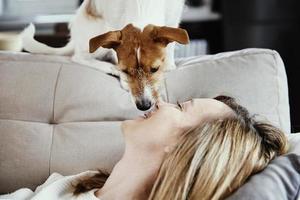 Woman relaxing on couch with her dog photo