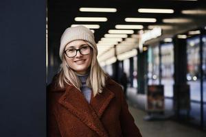 Woman in coat walks at city stret photo