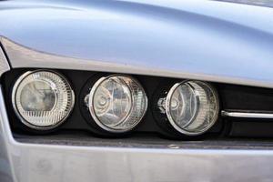 Headlight with halogen lamp on modern car, closeup photo