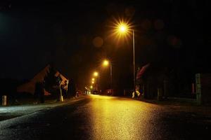 Empty road at night with street lights photo