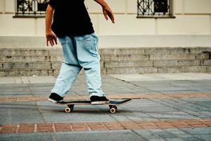 Skateboarder ride on skateboard at city street, close up photo