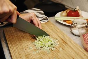 Woman cuts celery slices photo