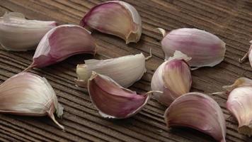 Garlic cloves on wooden table video