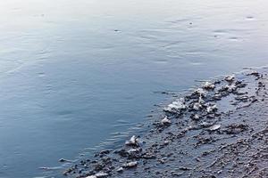 Thin ice on the river in the sunlight. Texture. Photo in high quality. Horizontal. Background.