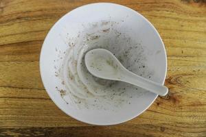 Empty dirty dish in with bowl and spoon photo