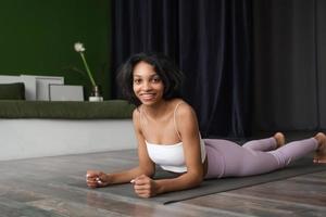 Happy healthy woman stretching at home. Wellness concept banner with copy space photo