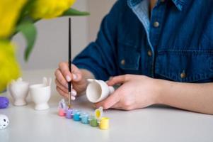 Pastel color Easter egg holder. Woman preparing for spring holiday photo