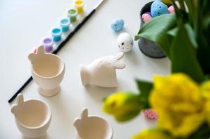 Top view easter banner with paint,eggs,brush and egg cups .Holiday mastreclass for children concept photo